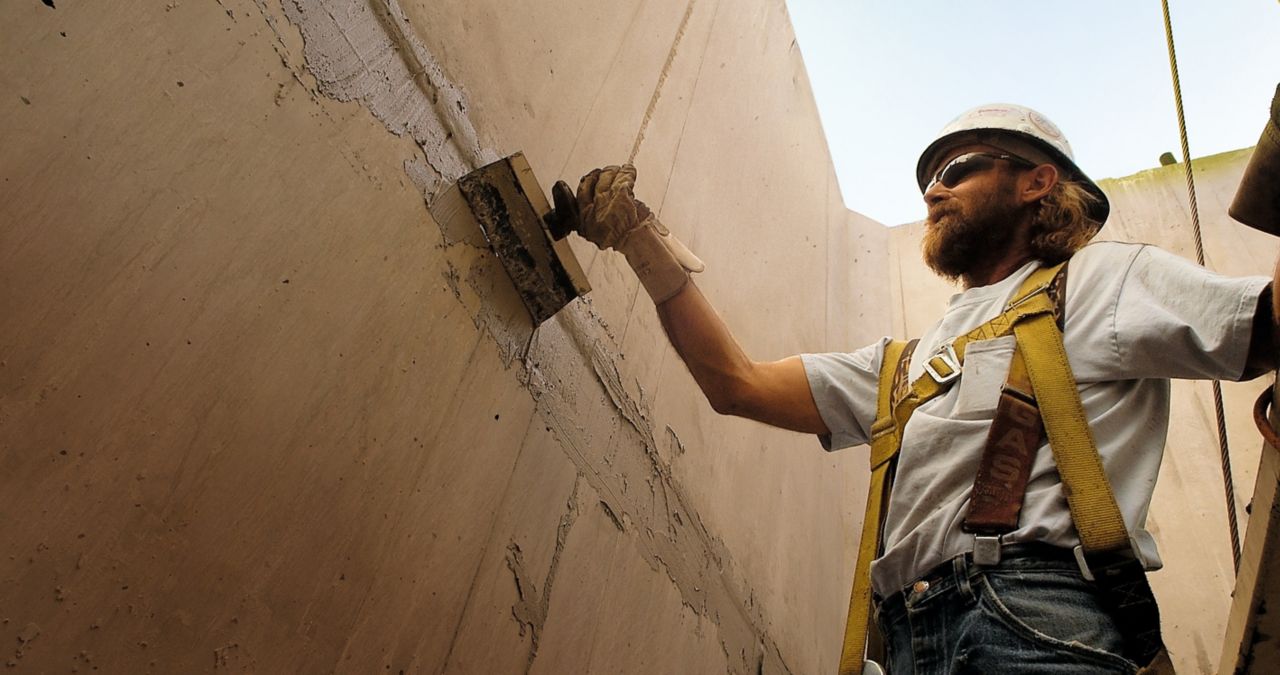 Man applying concrete repair mortar at Hoover Dam bypass bridge project