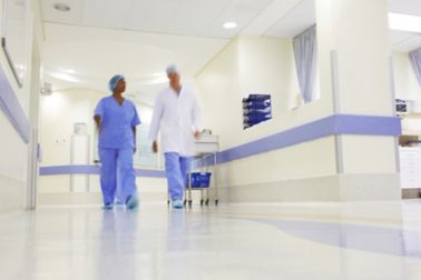 Doctor and nurse walking through hospital with wall and floor coatings