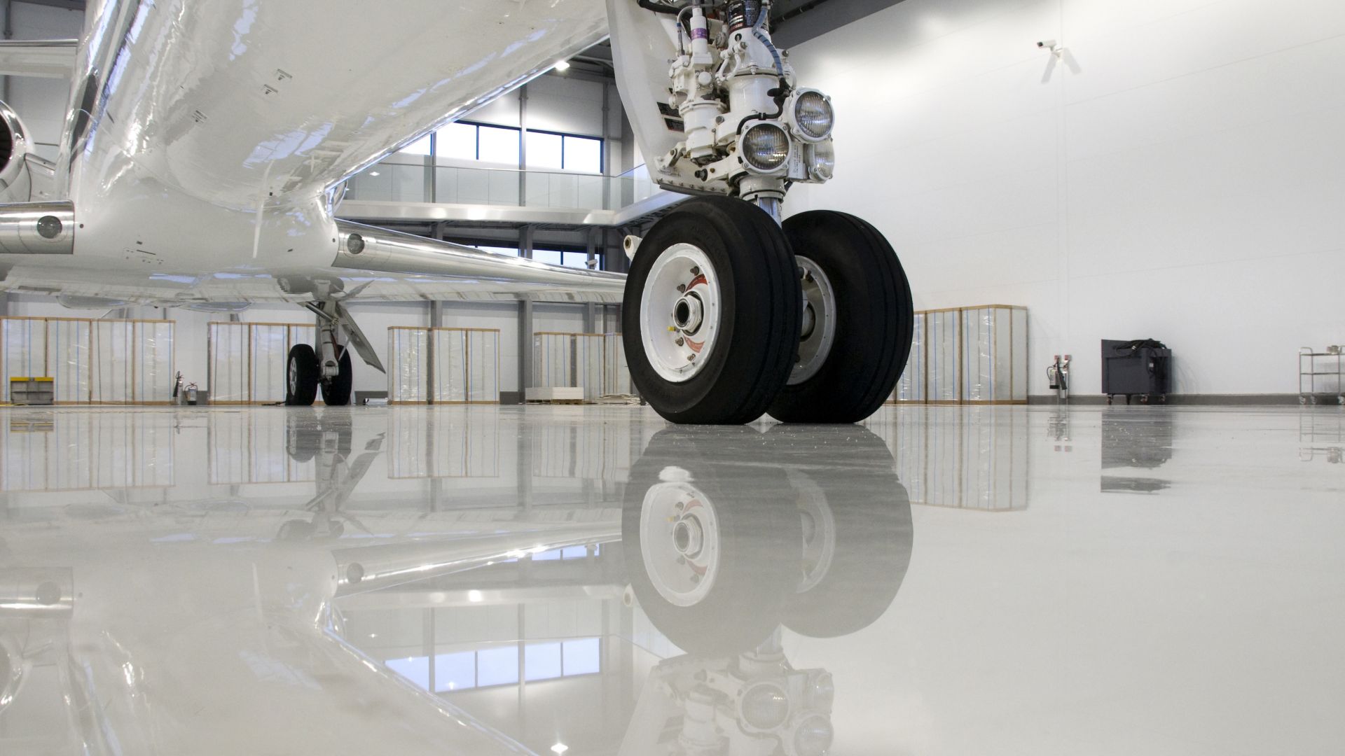 Plane wheel on industrial floor coating with Sikafloor high performance flooring system in aircraft hangar