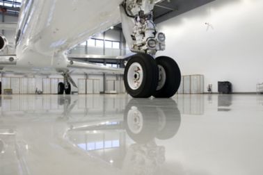 Plane wheel on industrial floor coating with Sikafloor high performance flooring system in aircraft hangar