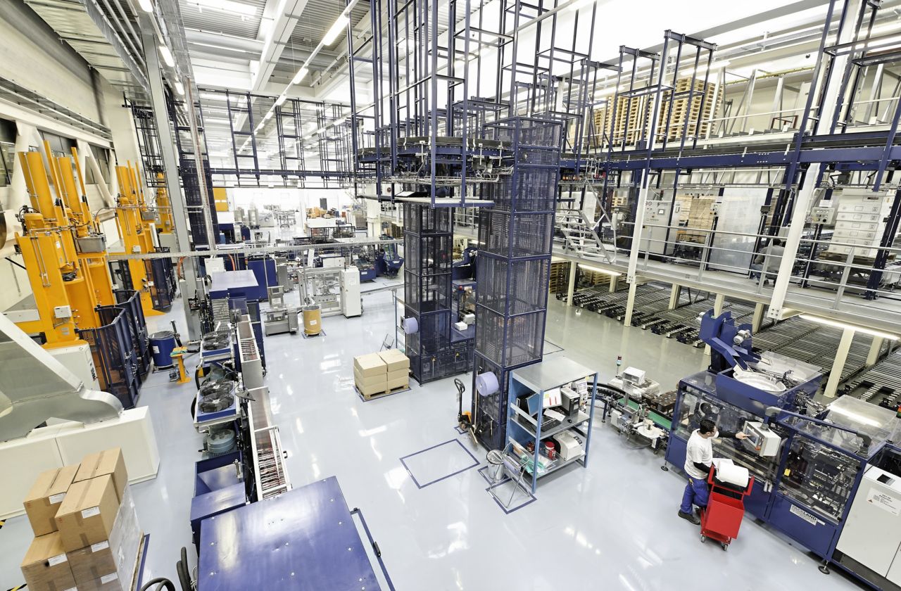 Clean white industrial plant interior floor with machines and equipment