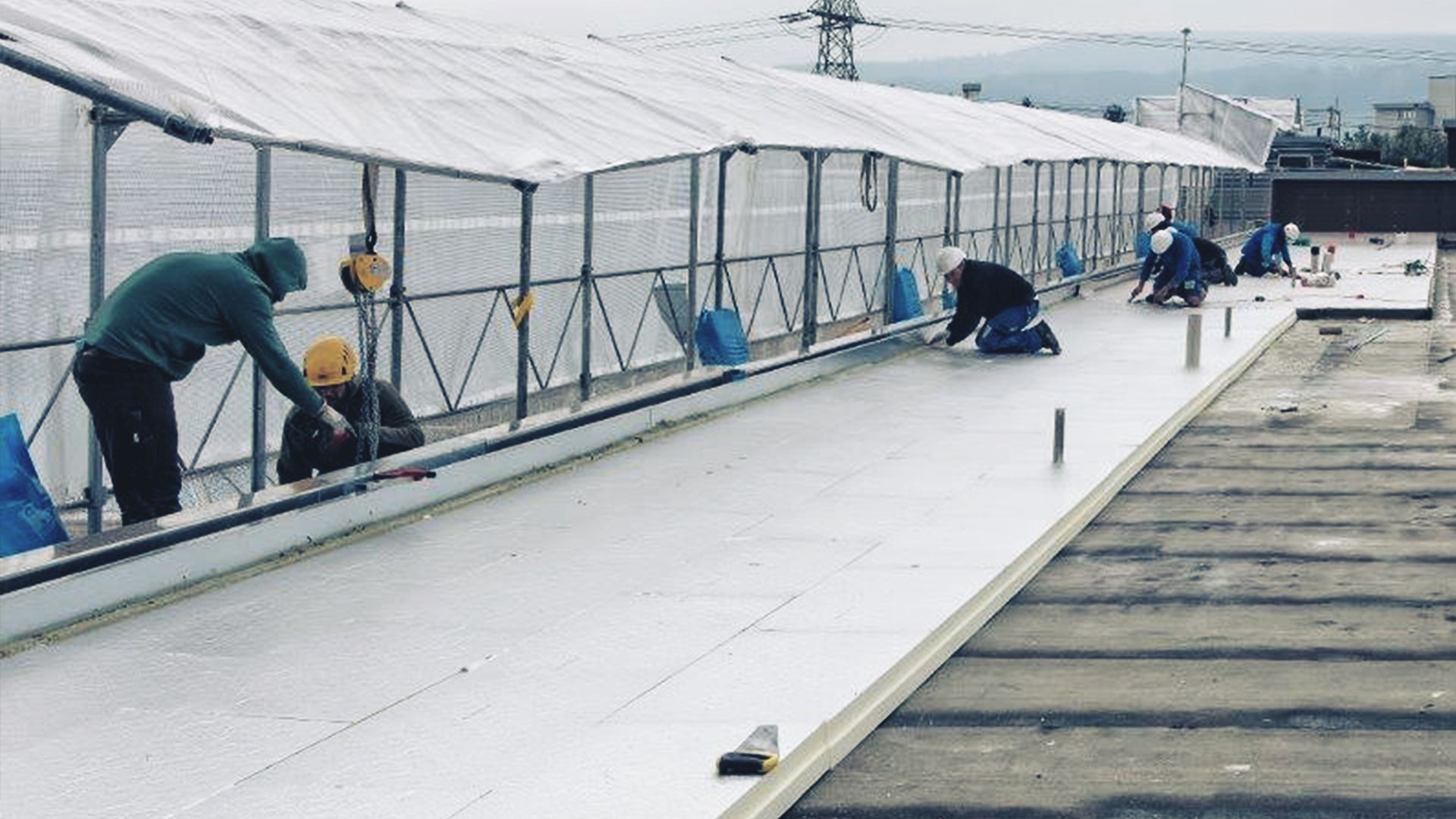 Men at work on a roof top
