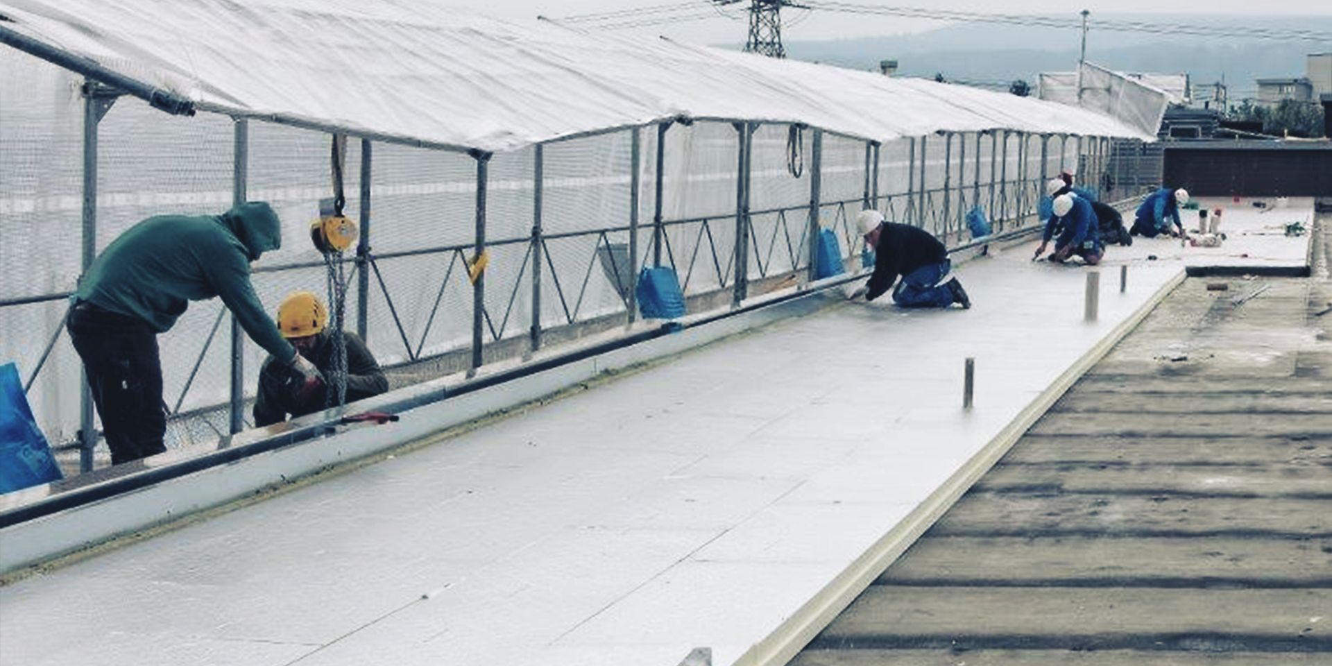 Men at work on a roof top