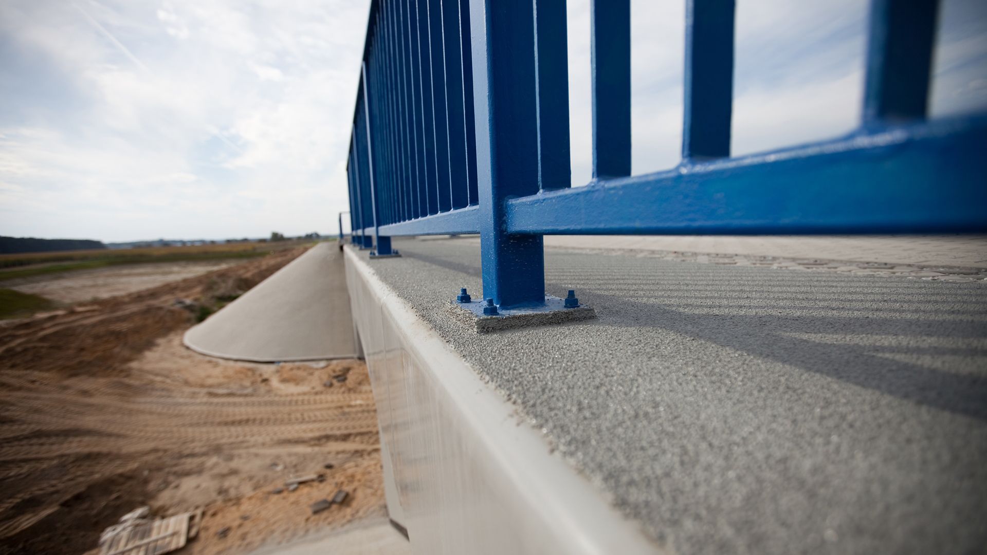Blue railing on highway bridge in Poland