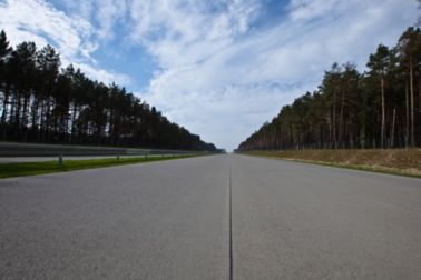 Highway road joint in Poland with trees forest
