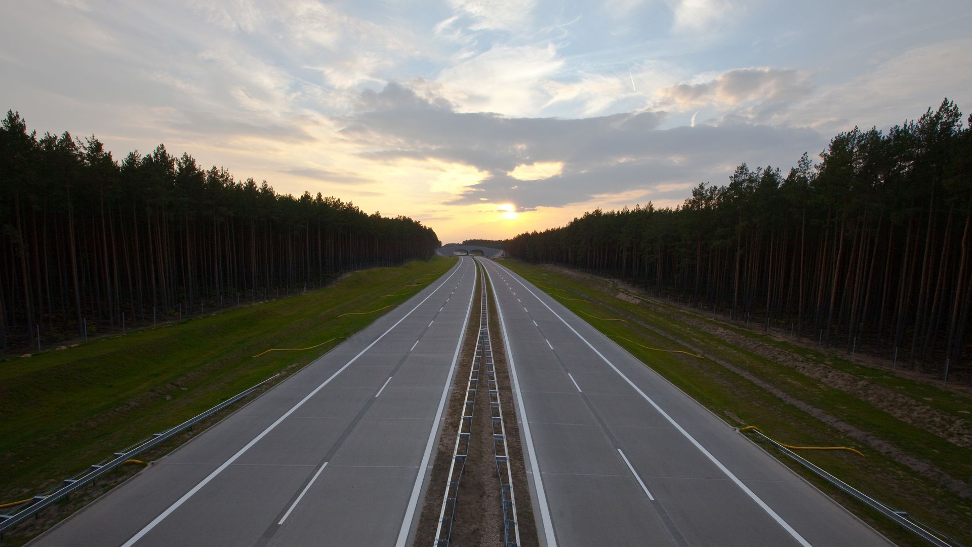 Highway road in Poland with forest and sunset