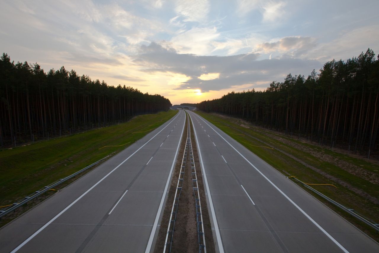 Highway road in Poland with forest and sunset