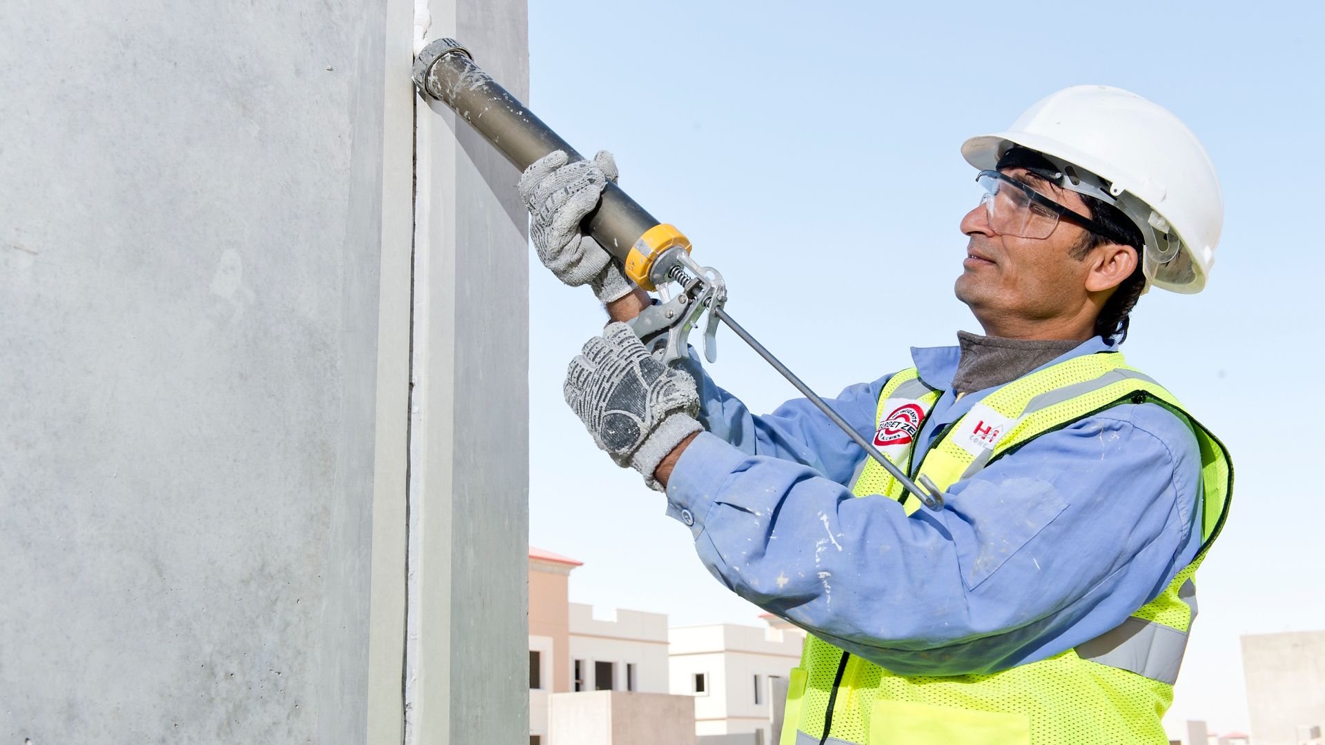 Man sealing joints of Musanda Villa structure with Sikaflex Construction+ at very high temperatures