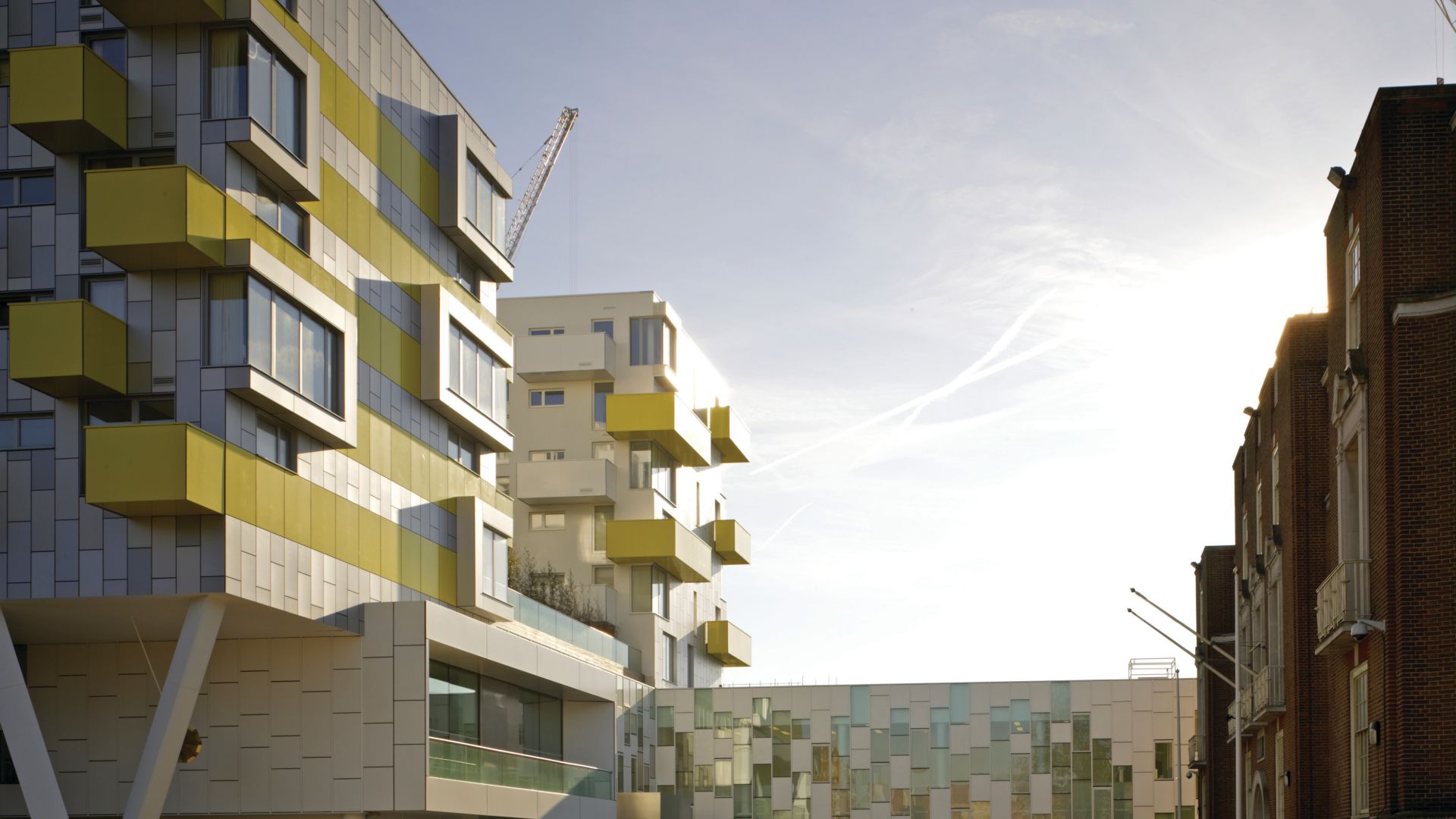 Apartment house with yellow colored panel parts