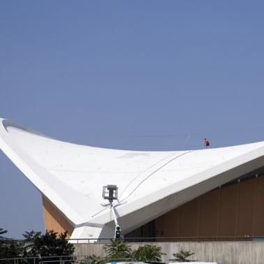 Construction worker applying Sikalastic liquid applied membrane on Congress Hall roof in Berlin Germany