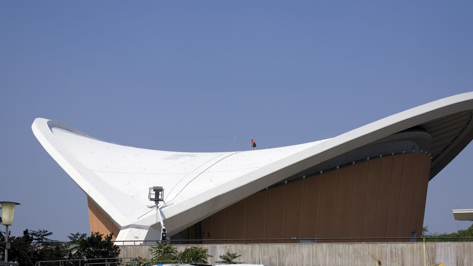 Construction worker applying Sikalastic liquid applied membrane on Congress Hall roof in Berlin Germany