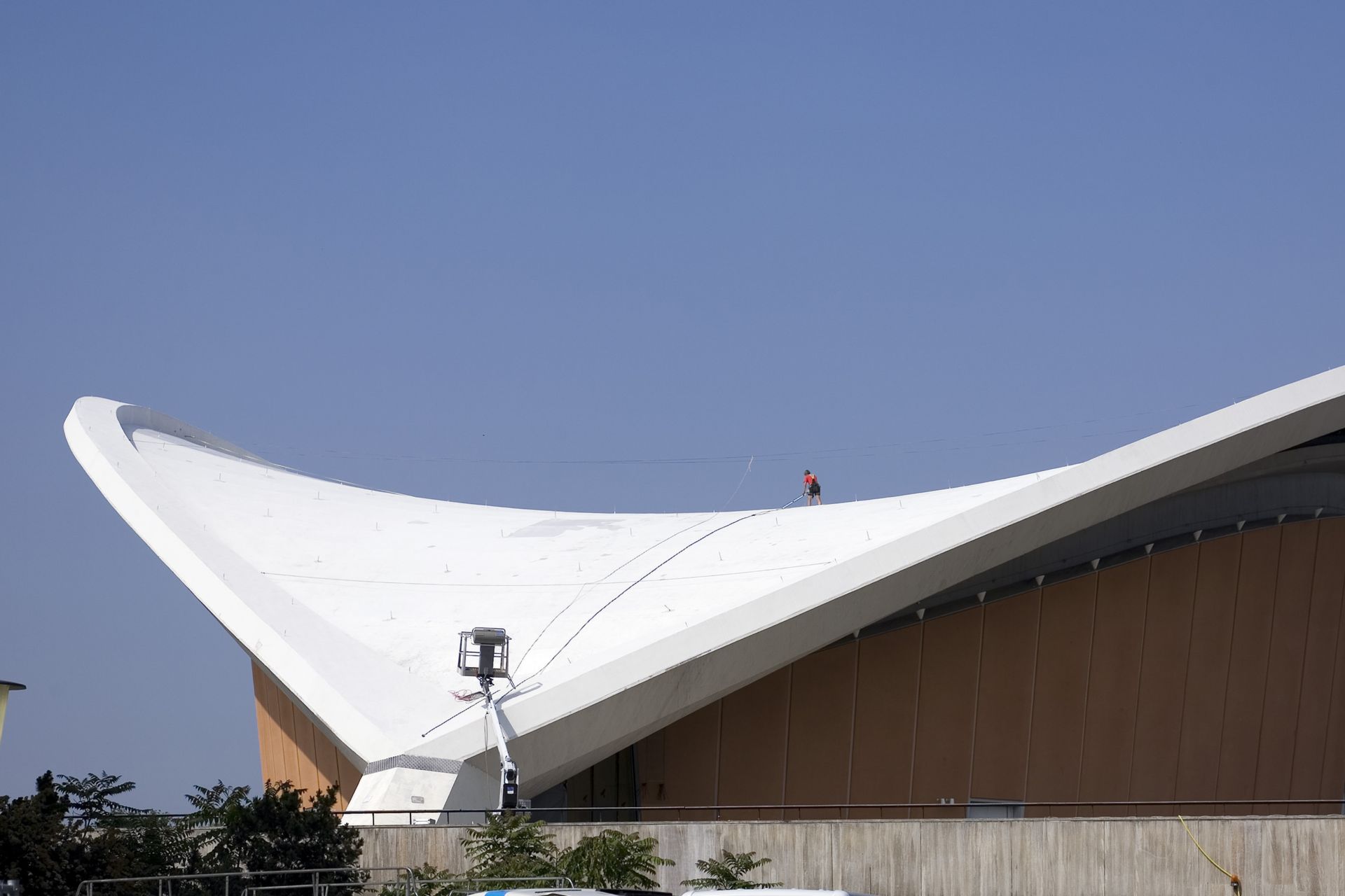 Construction worker applying Sikalastic liquid applied membrane on Congress Hall roof in Berlin Germany