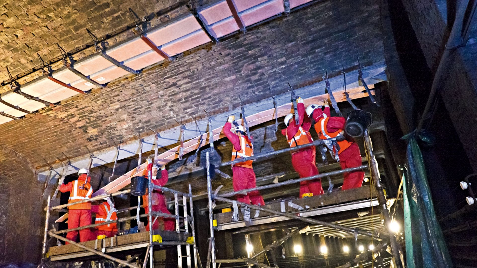 Construction workers install Sika Carbodur CFRP strengthening plates