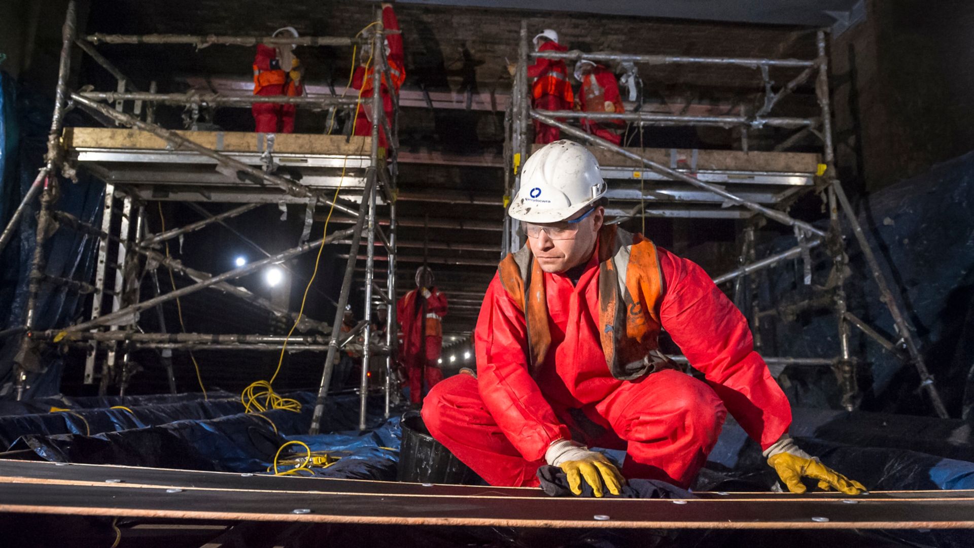 Construction worker prepares Sika Carbodur CFRP strengthening plates