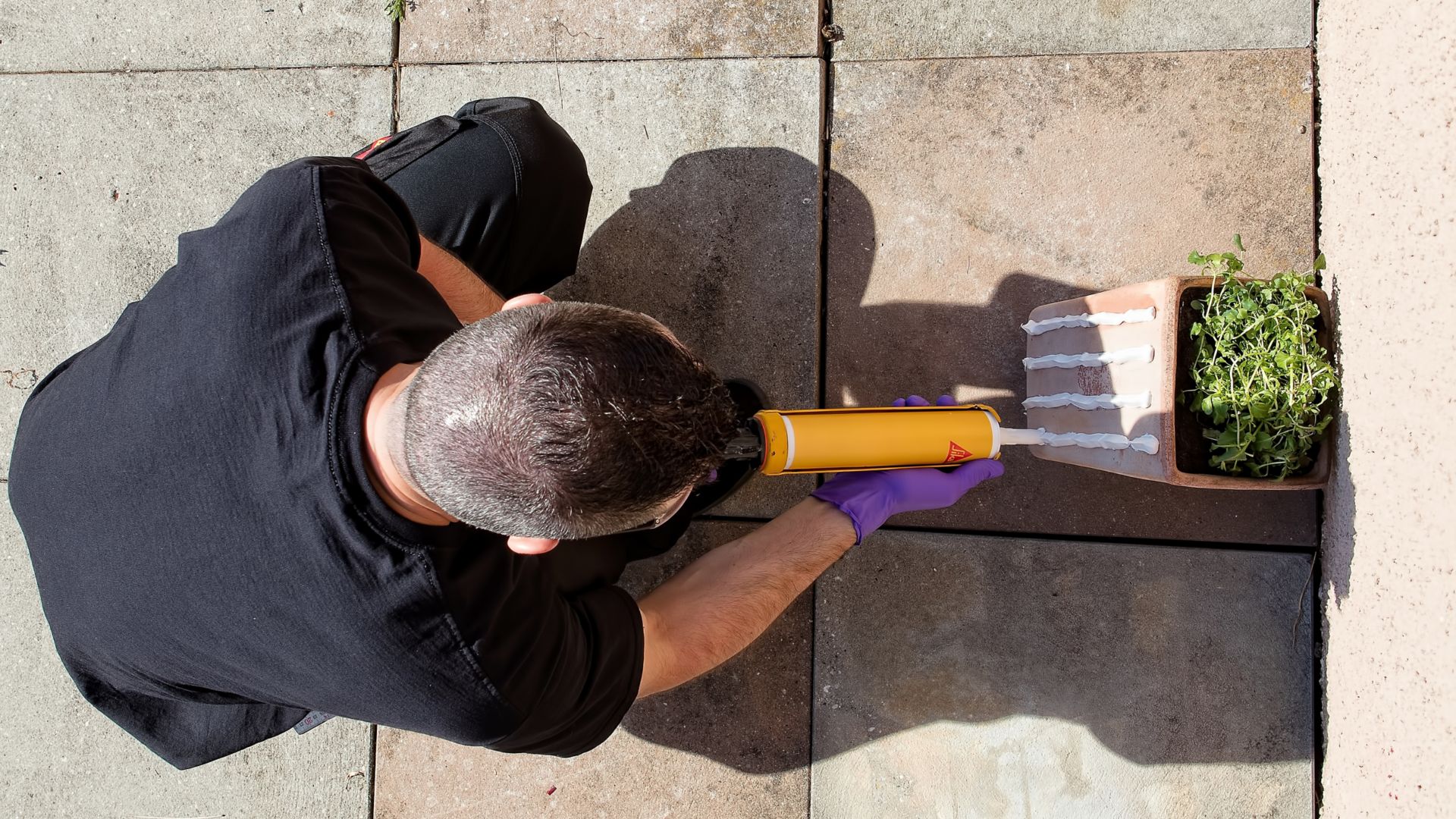 Man Applying Construction Adhesive