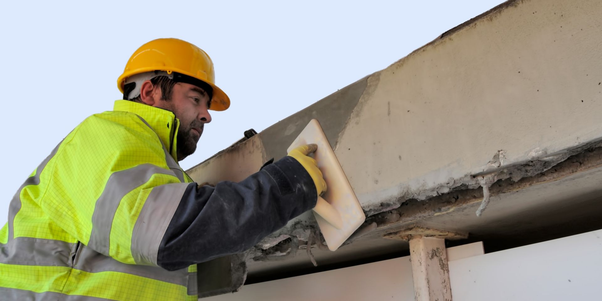 Man repairing concrete bridge with Sika repair mortar