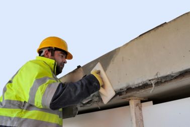 Man repairing concrete bridge with Sika repair mortar