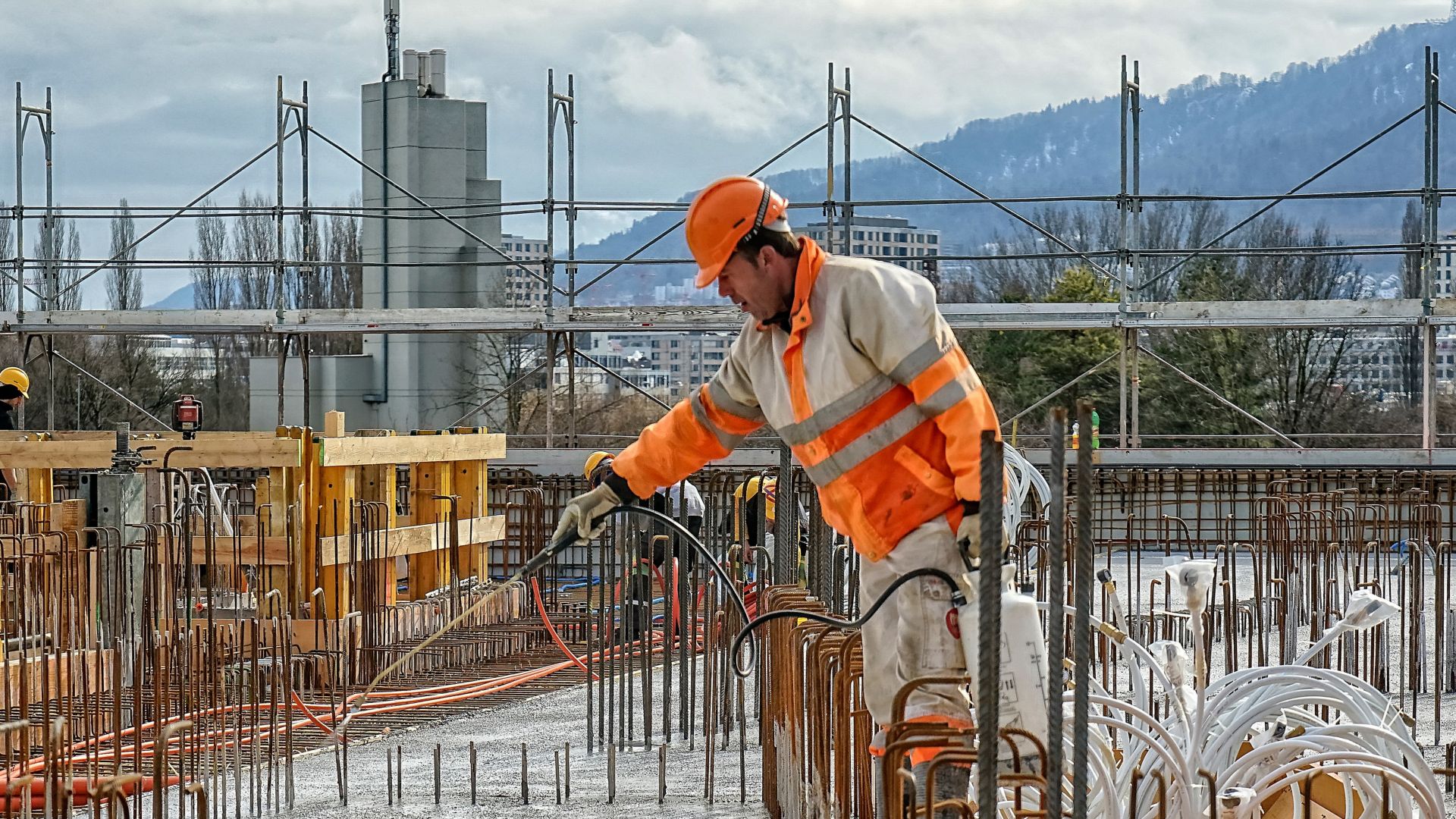 Worker man spraying concrete surface with Sika® Antisol® concrete curing compound