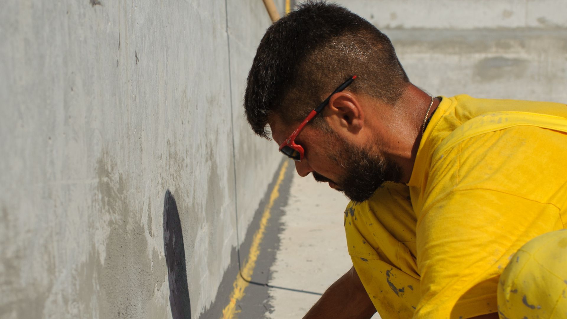 Man waterproofing at the Epirus Sport and Health Center in Ioannina, Greece