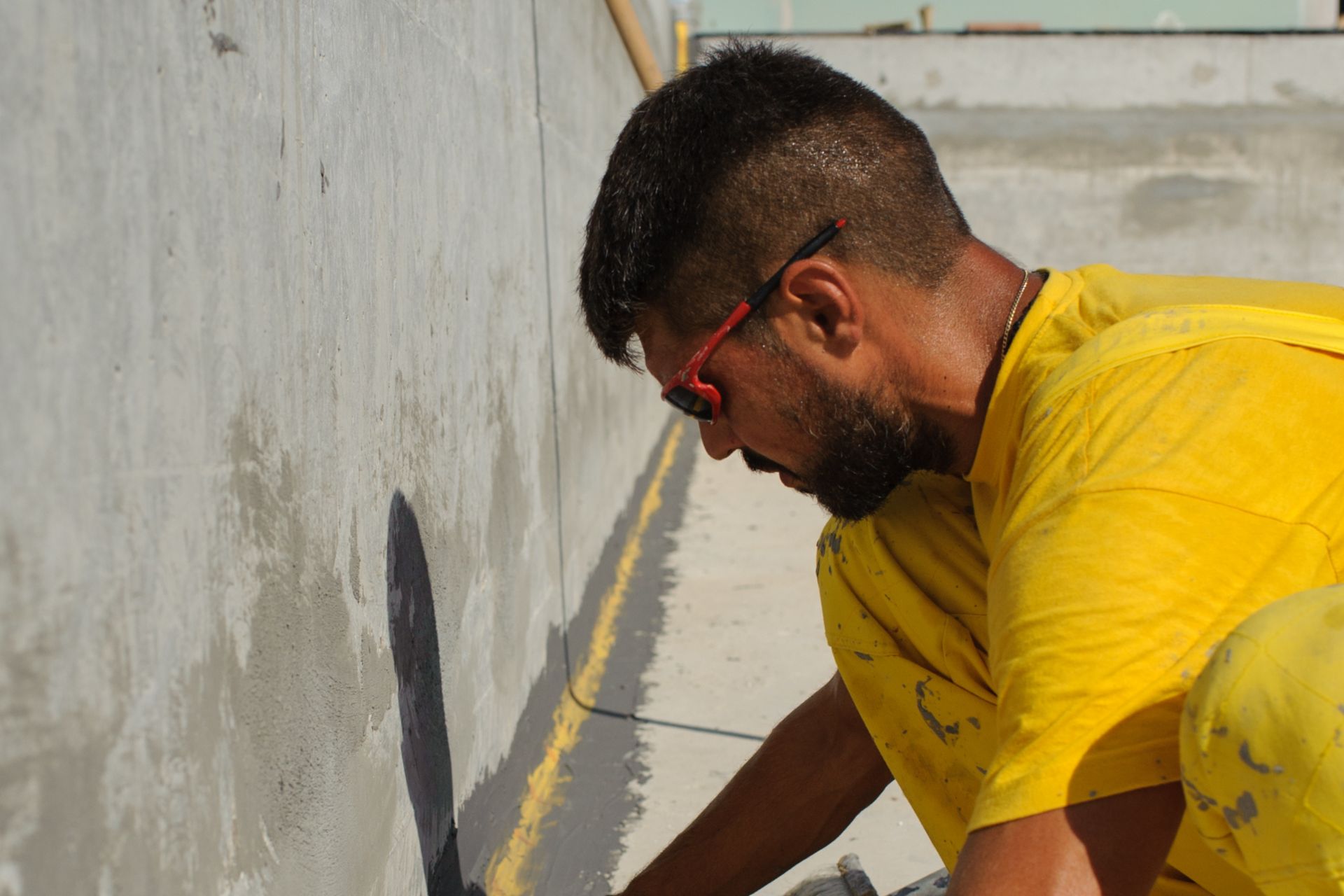 Man waterproofing at the Epirus Sport and Health Center in Ioannina, Greece