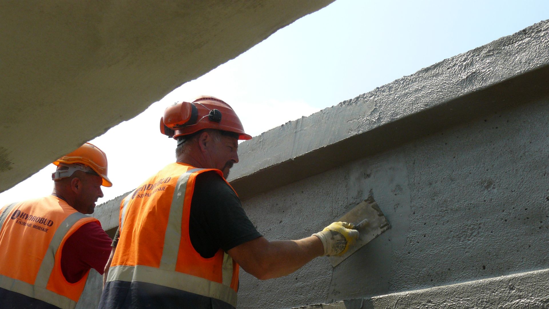 Men repairing concrete bridge with Sika repair mortar