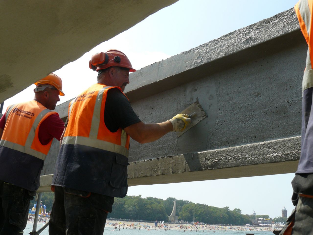 Men repairing concrete bridge with Sika repair mortar