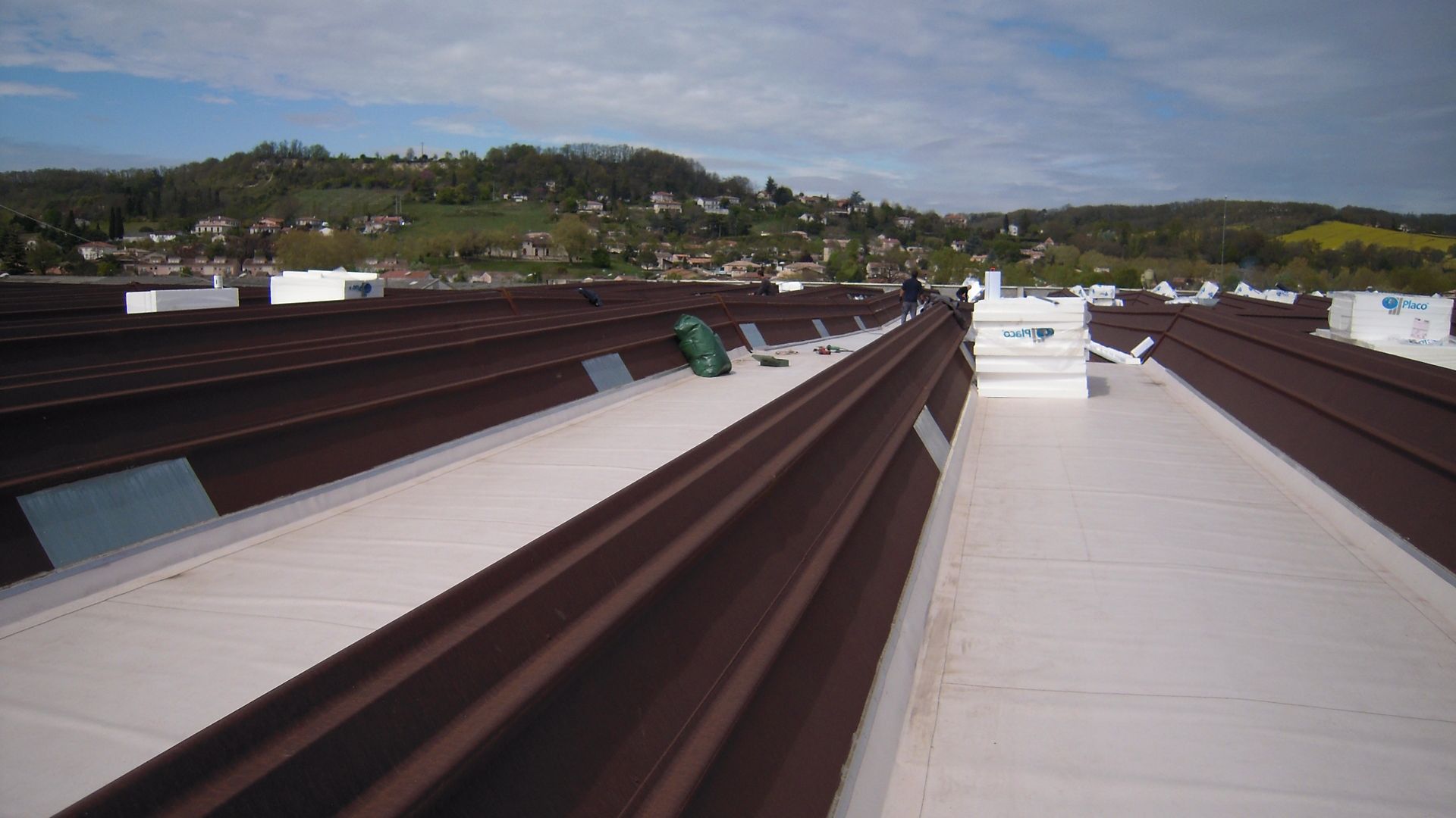 Metal roof after renovation repair with single ply roof membrane