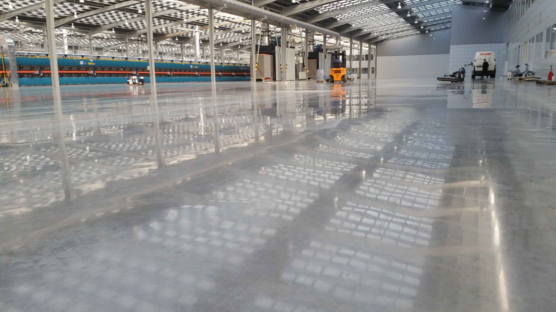 Polished concrete floor with dry shake hardener in production factory warehouse using Sika Concria