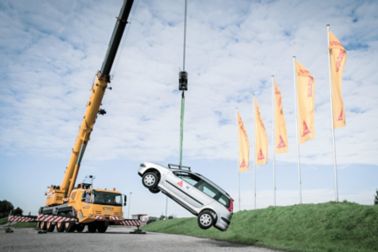 Car being lifted with a crane from the car windshield
