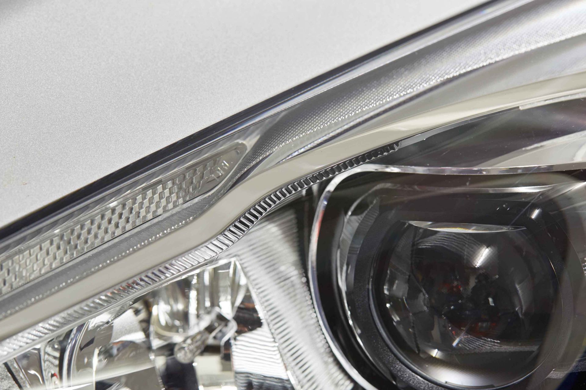 Close up view of vehicle headlamp bonded with Sika Exterior Adhesive Solutions