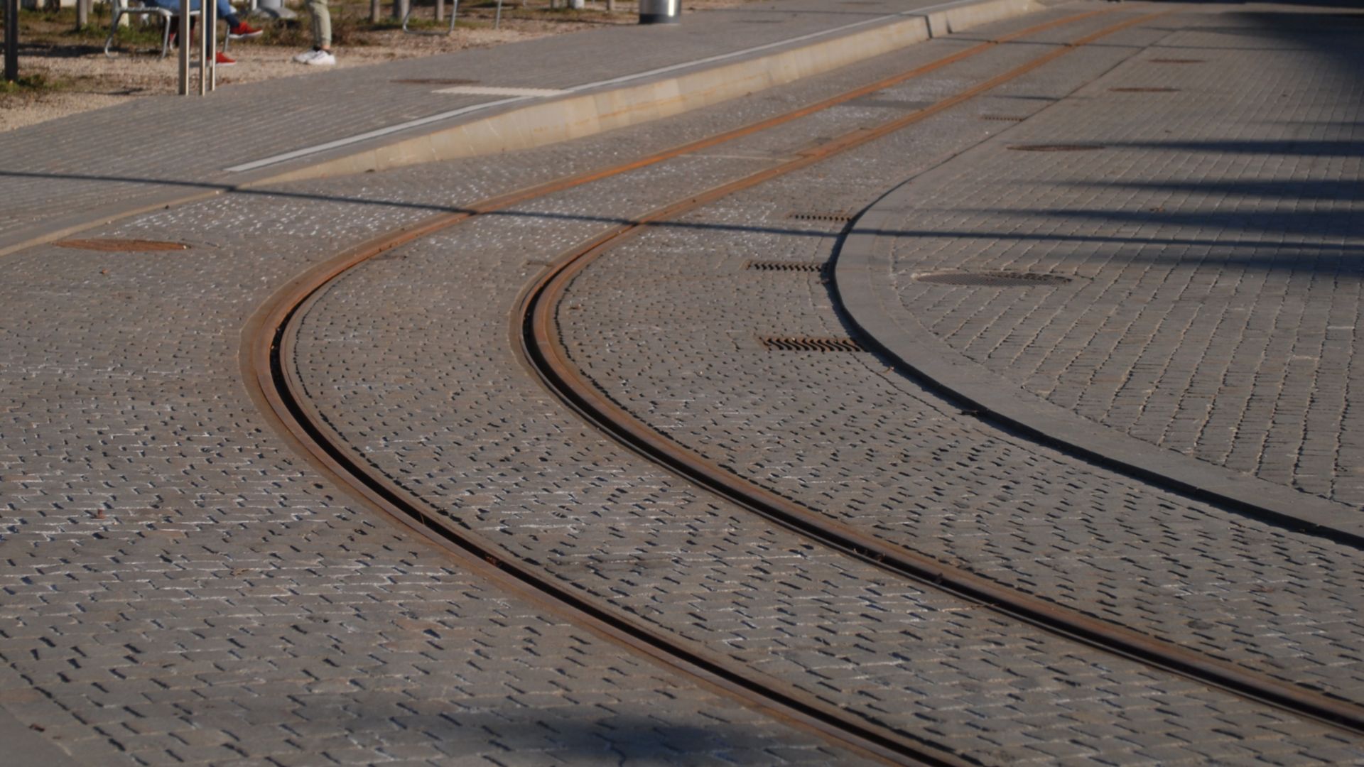 Rail fixing tram track embedded into cobblestone street in Zurich, Switzerland