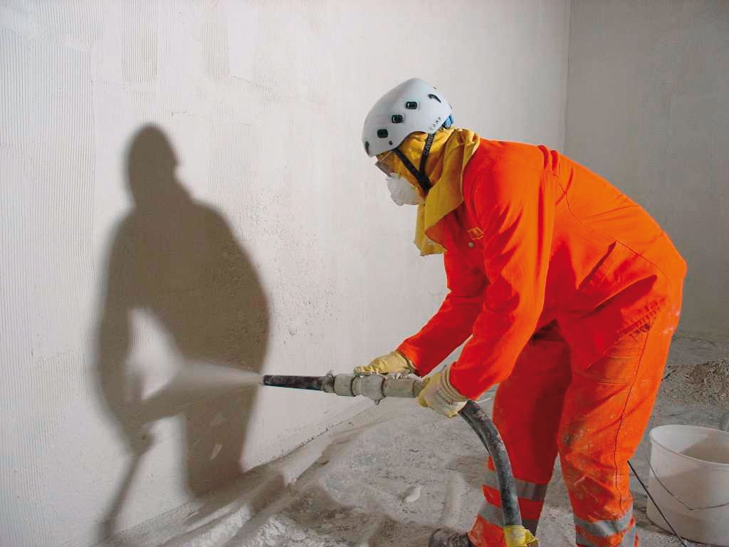   Man spraying mortar on the wall