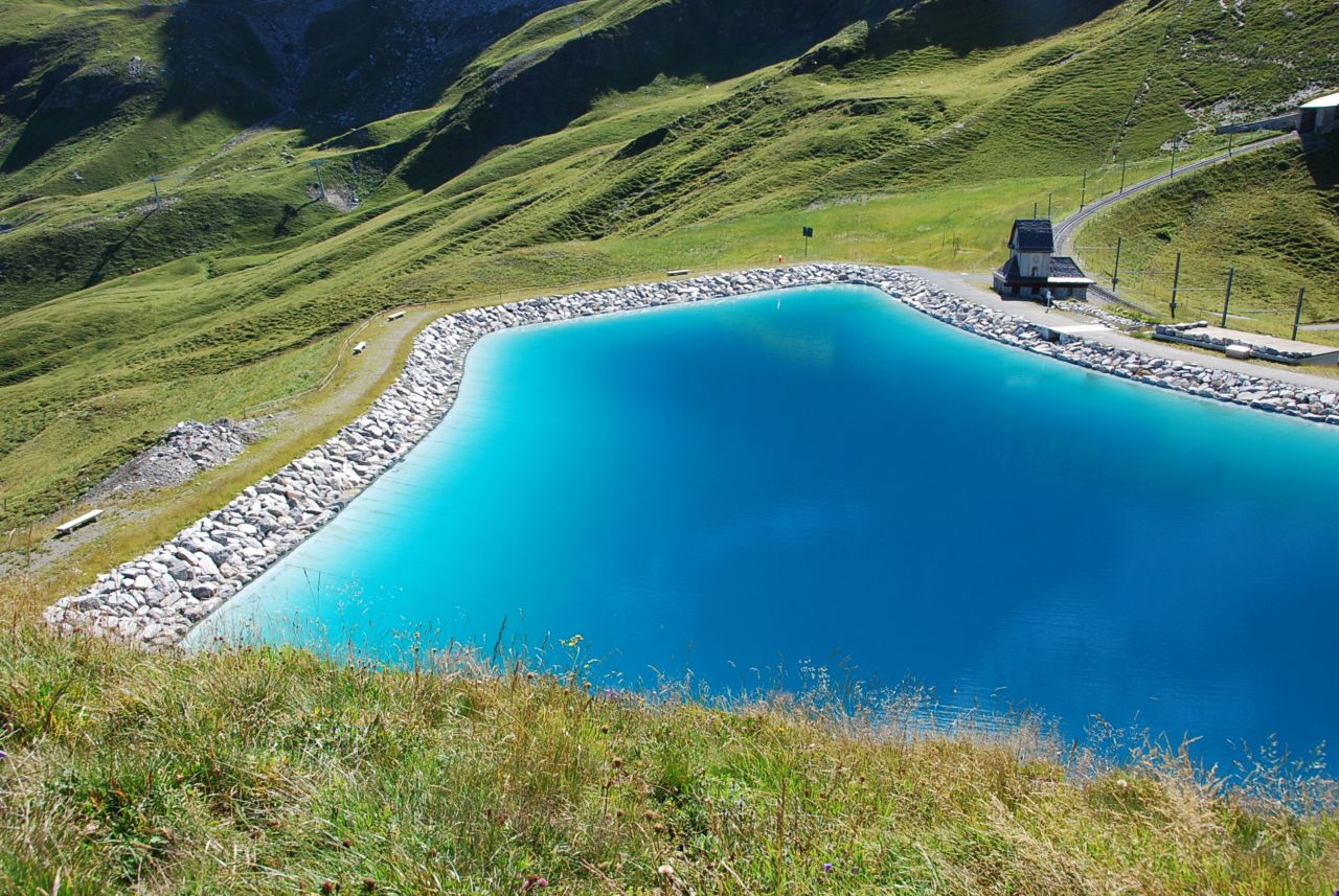 Retention pond in grassy mountains with potable water