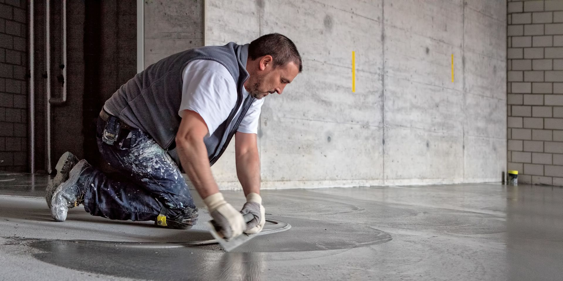 Man applying SikaScreed on floor