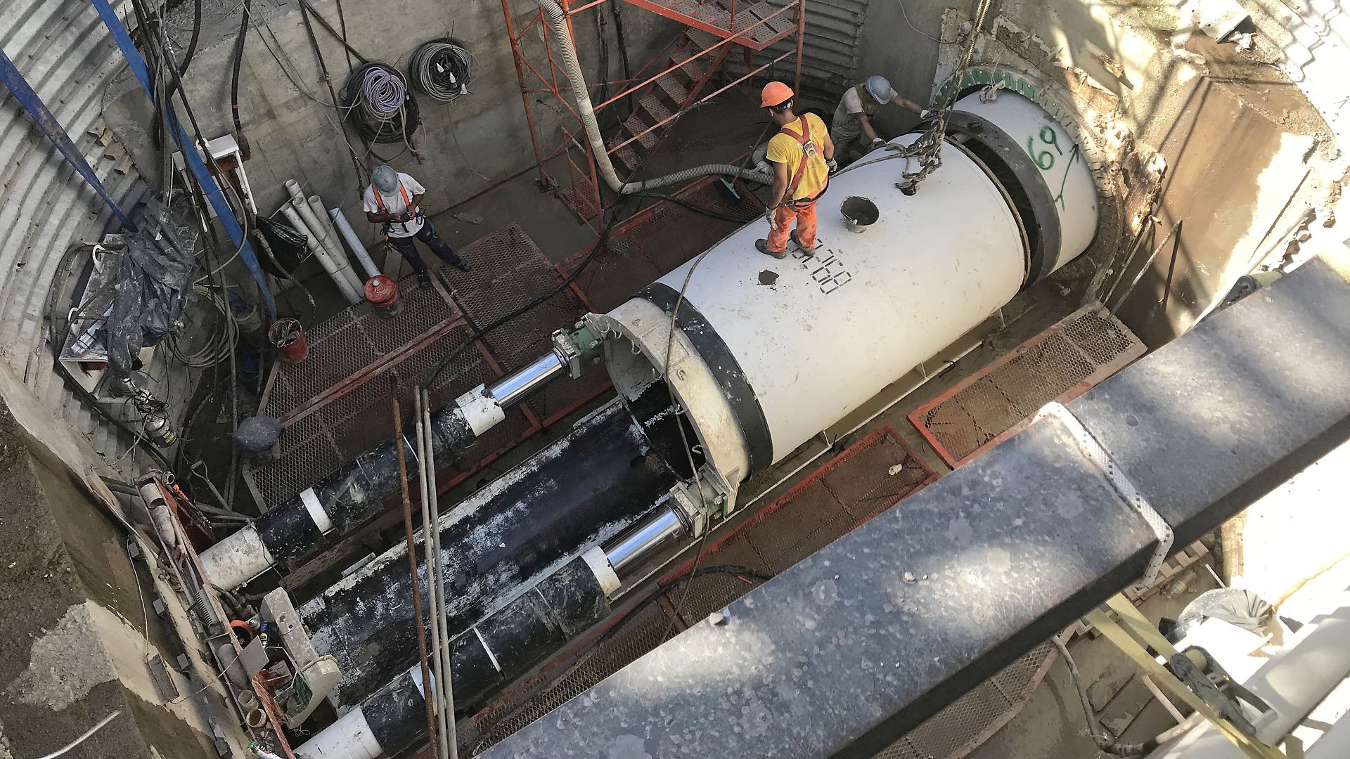 Man standing on a tunnel boring machine, excavating tunnel in Buenos Aires
