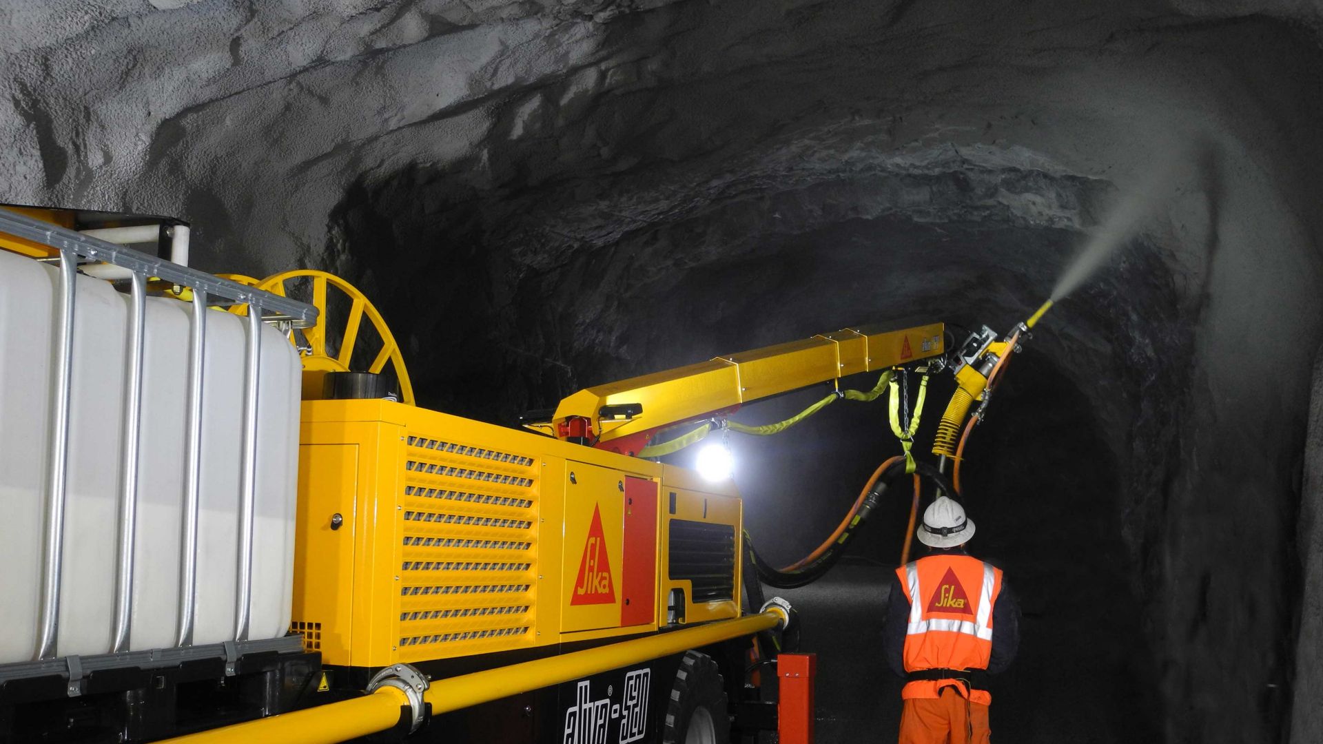 Sika engineer supervising concrete spraying in mine tunnel with Aliva shotcrete machine