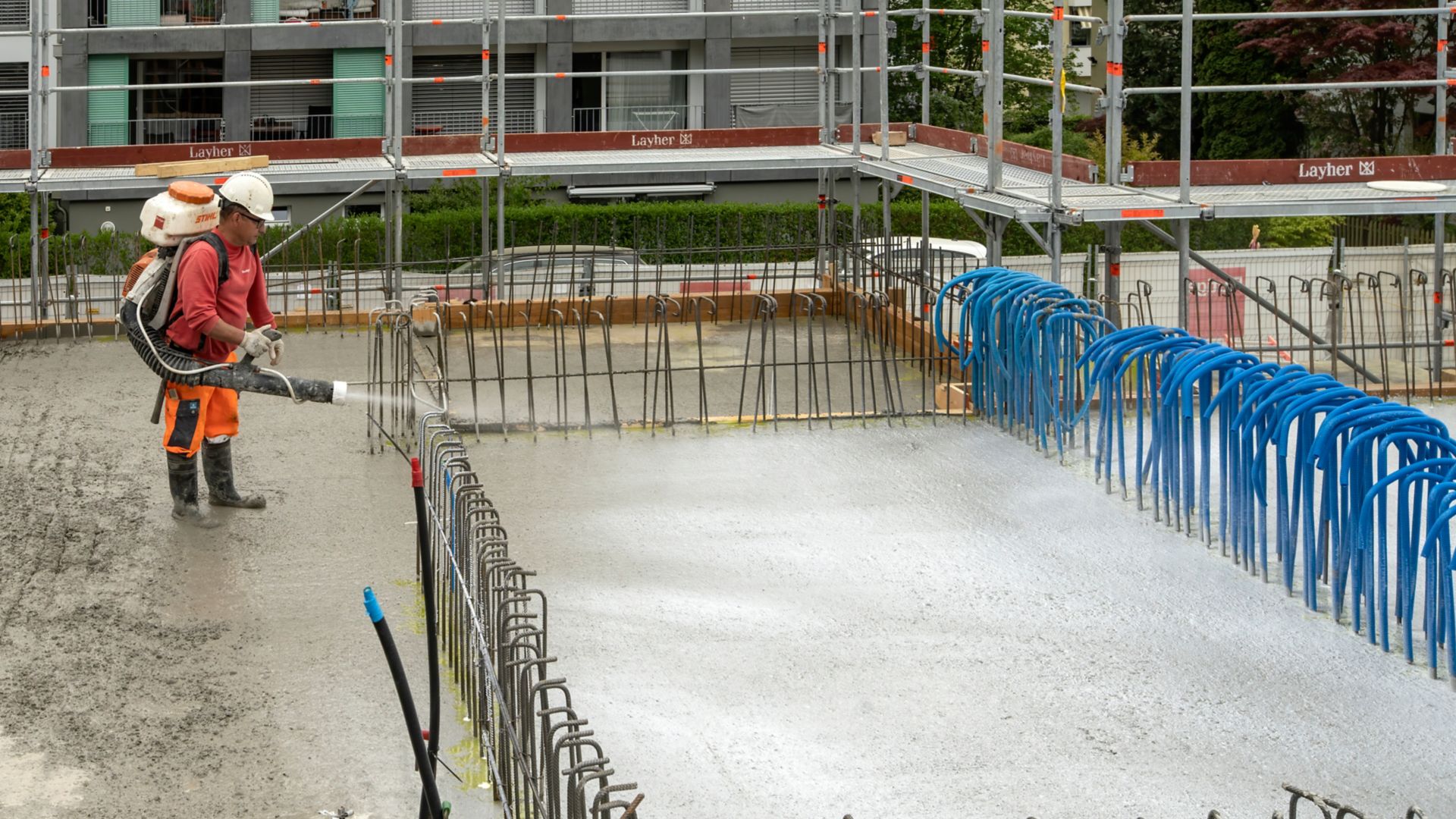 Man applying concrete on construction site with reinforcement and Sika® Antisol® curing compound