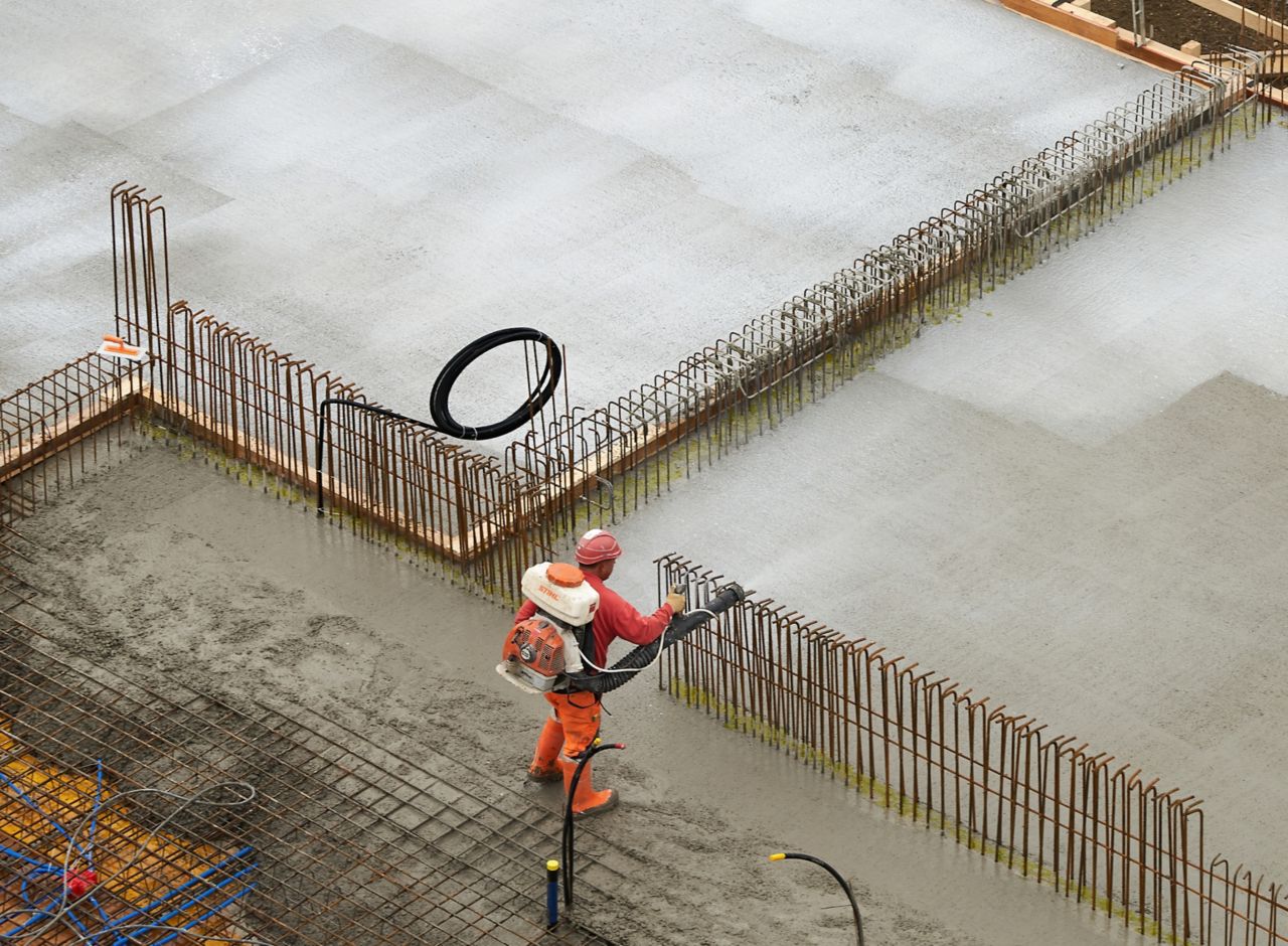 Man applying concrete on construction site with Sika® Antisol® curing compound