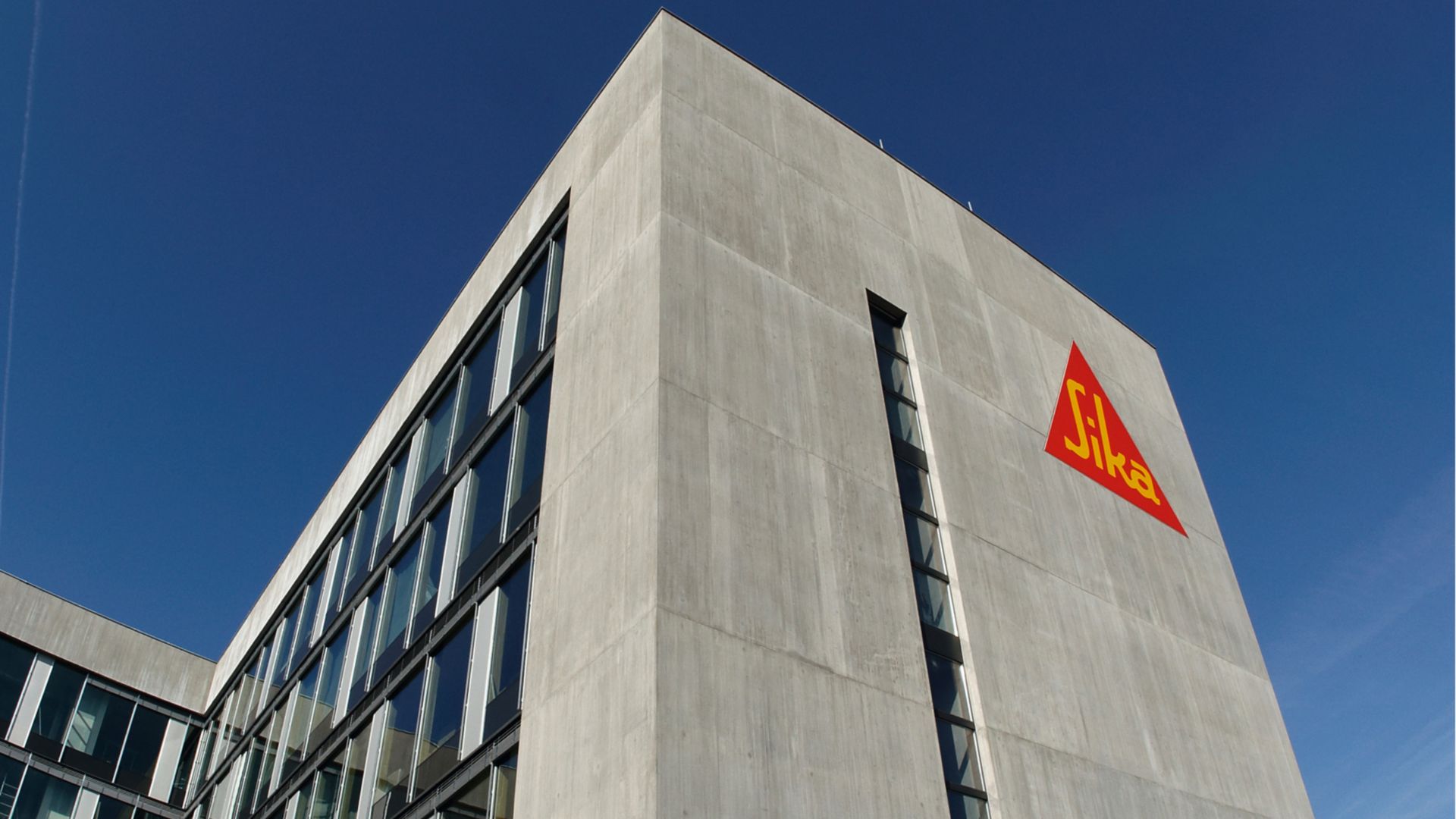 Architectural concrete facade on Sika office building with weather joint sealing glazing