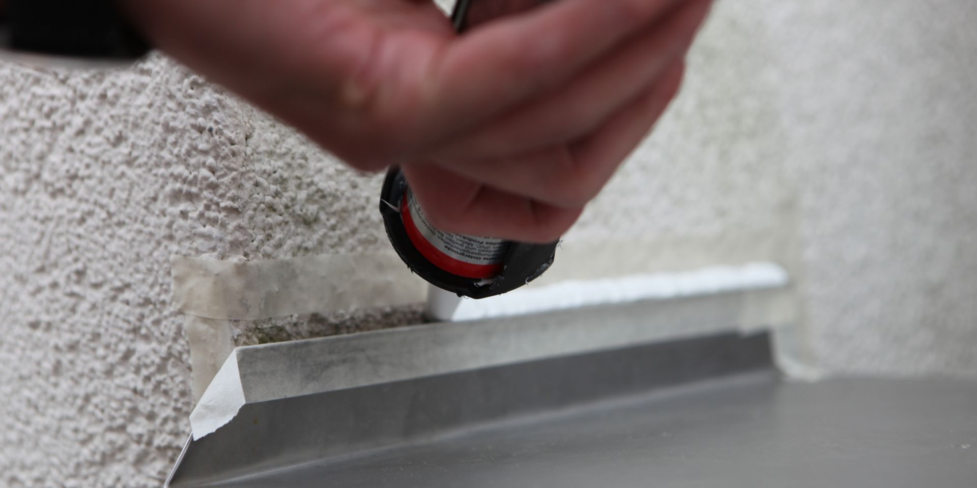 Sika roof sealant being applied by hand in sealing tube applicator