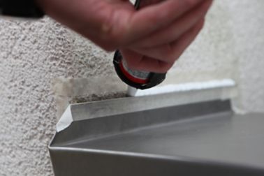 Sika roof sealant being applied by hand in sealing tube applicator