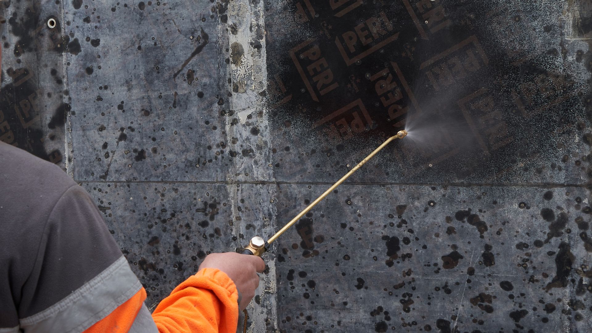 Man spraying Sika® Separol® formwork release agent on concrete on construction site