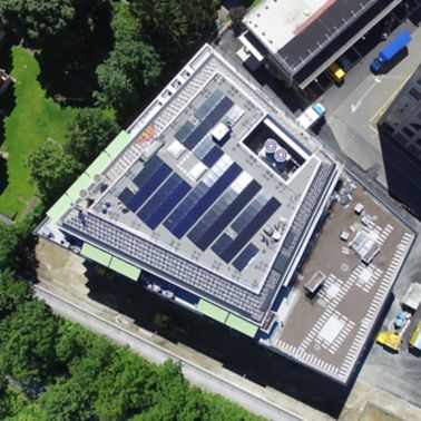 Solar PV panels mounted to roof at Limmat building in Zurich drone view
