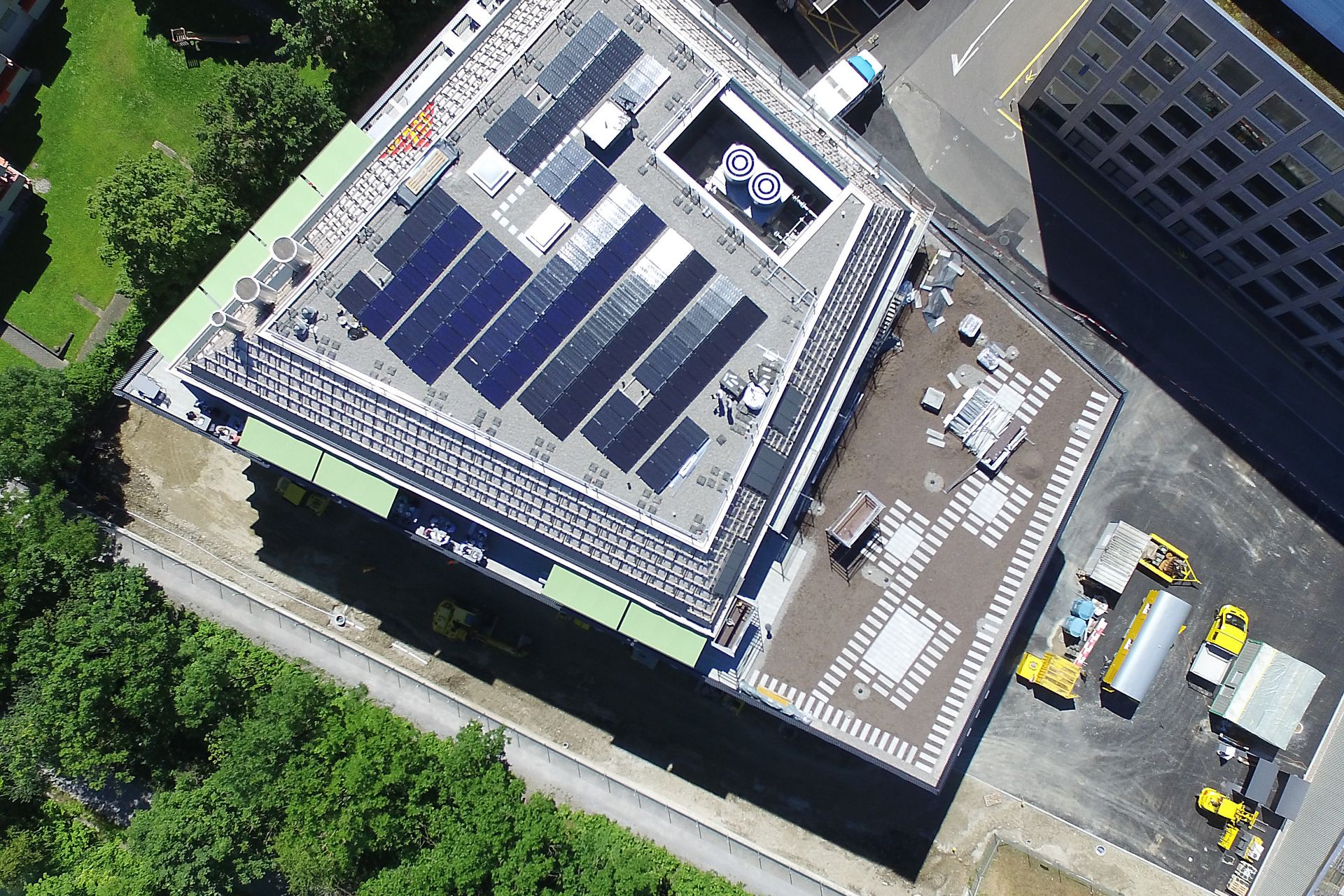 Solar PV panels mounted to roof at Limmat building in Zurich drone view