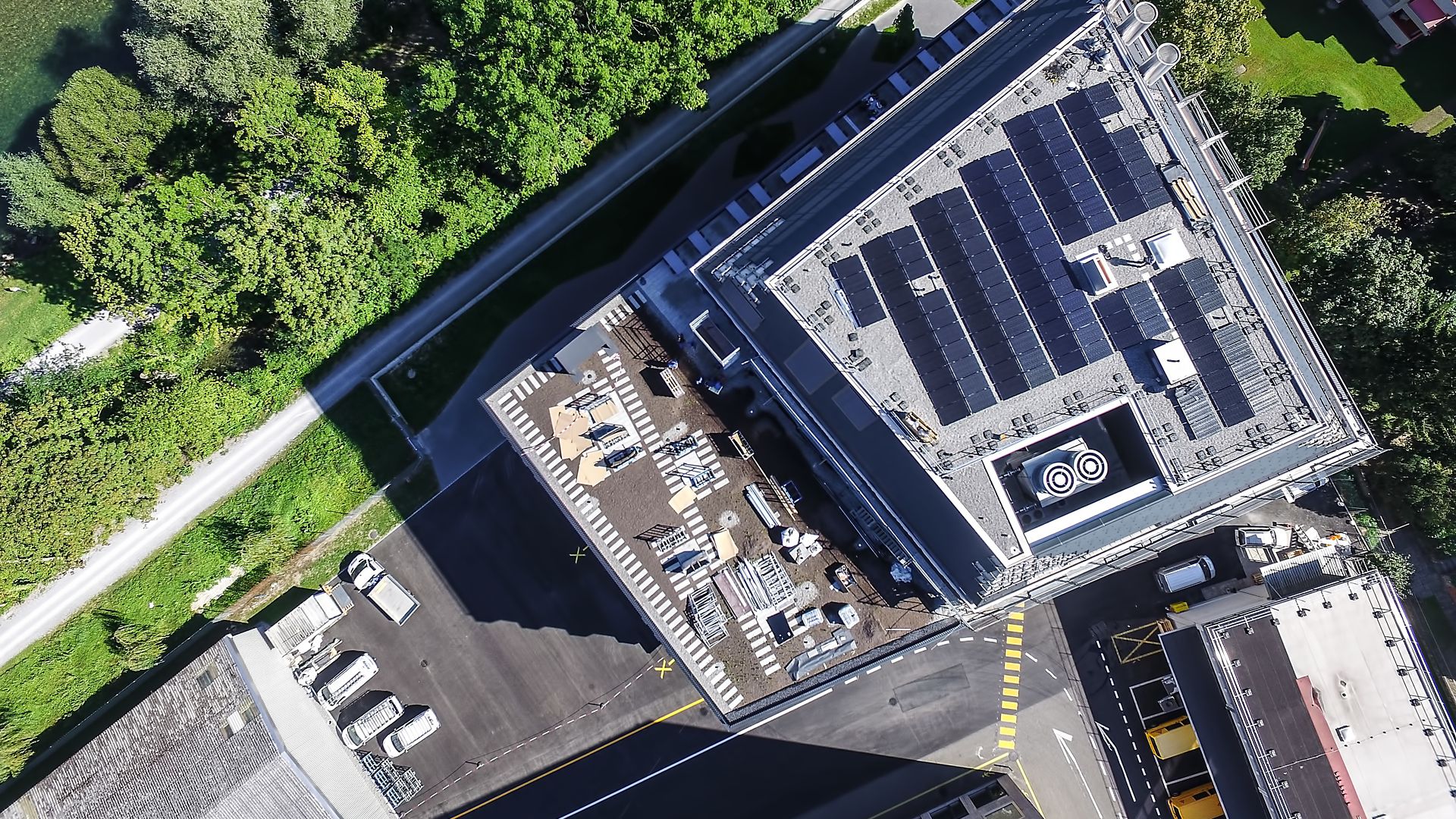 Solar PV panels mounted to roof at Limmat building in Zurich drone view