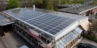 Photovoltaic roof panel system on a commercial building
