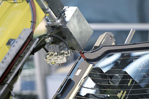 Applying windshield to a car with a robot in a factory