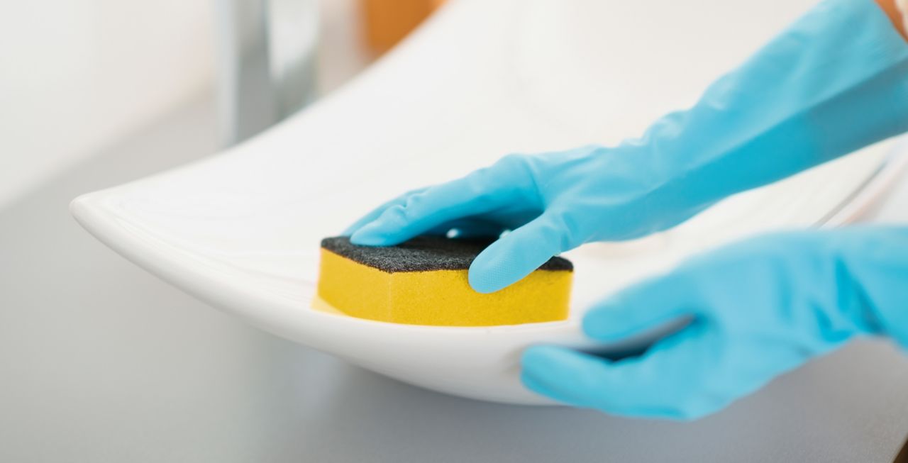 A woman cleaning with an abrasive sponge adhesive bonded with SikaForce and SikaMelt
