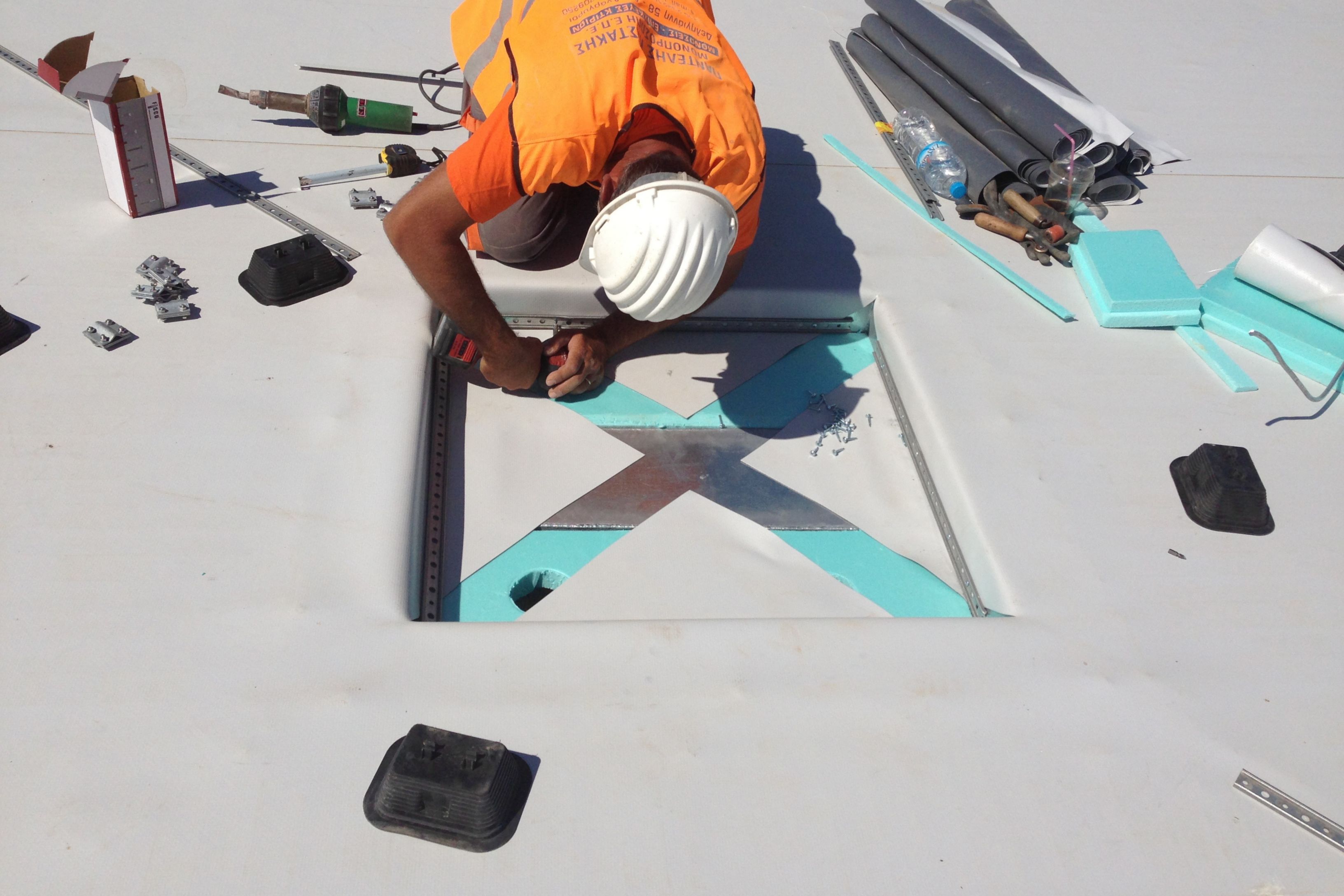 Man working on the roof of the SNF Cultural Center