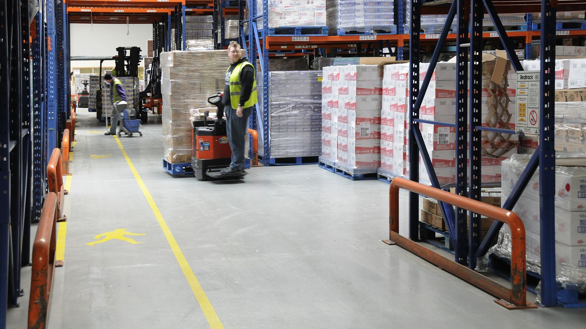 Storage warehouse shelves and floor and worker with palette